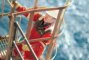 A crew member climbs a ladder on the Brent Delta platform in the North Sea, off the coast of the United Kingdom (photo)