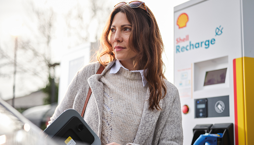 Woman using Shell Recharge which offers electric vehicle drivers access to recharge points in 19 countries (photo)