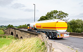 Shell tanker, driving through the countryside, on route to deliver fuel to a retail station. (photo)
