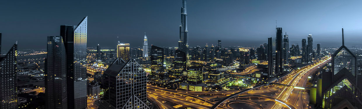 Dubai at night with a view of the Burj Khalifa and other illuminated buildings (photo)