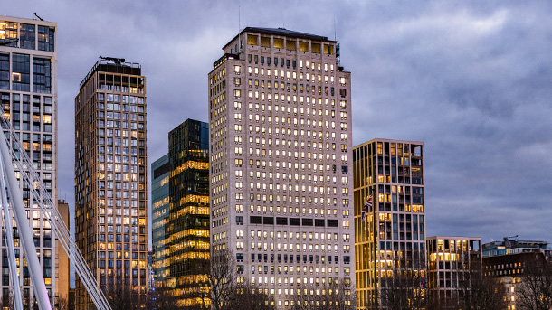 Shell Centre London and other buildngs behind at dusk with internal lights on 