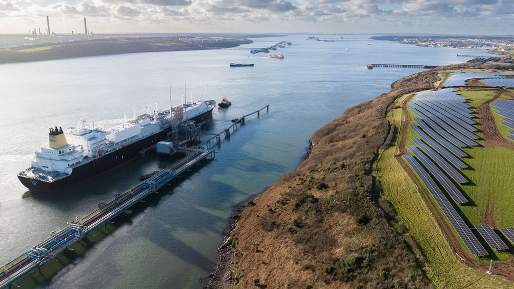 Aerial view of Megara LNG tanker berthing at Dragon’s jetty in Milford Haven, UK.  Solar panels to the right at Dragon’s Renewables Park. (photo)