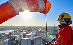 Shell employee standing atop a refinery