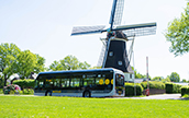 Dutch hydrogen bus in front of a windmill