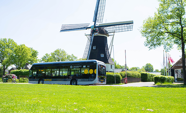 Dutch hydrogen bus in front of a windmill