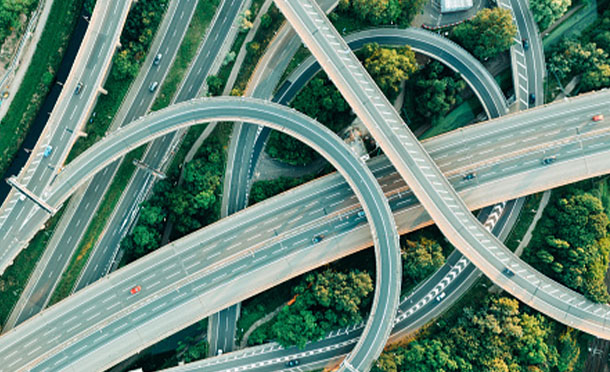 Aerial view of a junction of two motorways with trees around