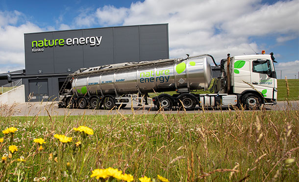 Nature Energy Truck leaving the Nature Energy Facility with blue sky behind