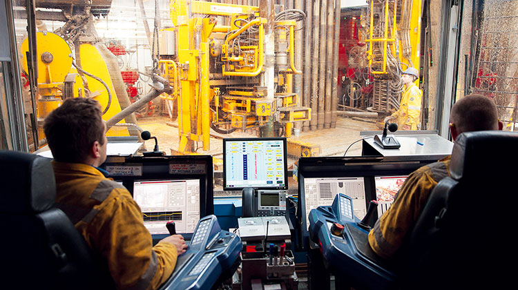Two men sitting in a drilling room (photo)