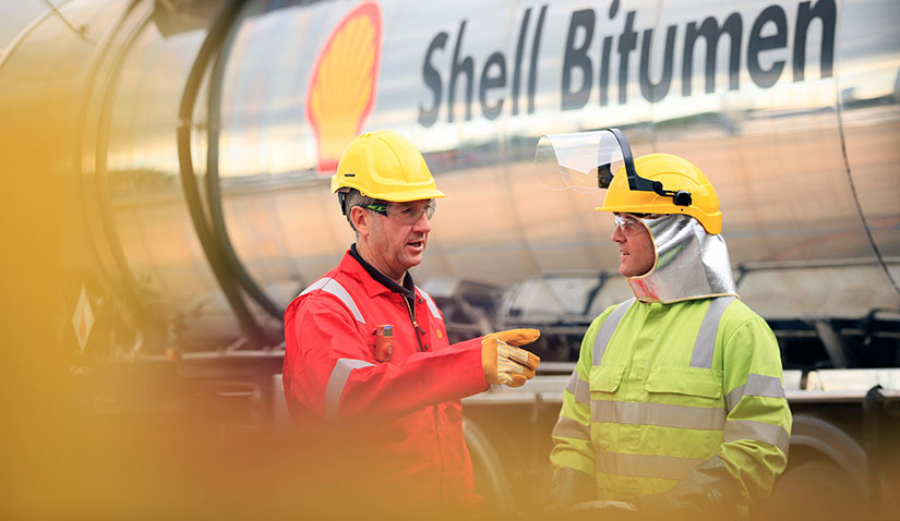 DHL Truck driver preparing the flex hose with Shell Operator from Shell Bitumen truck at UK PMB plant (photo)