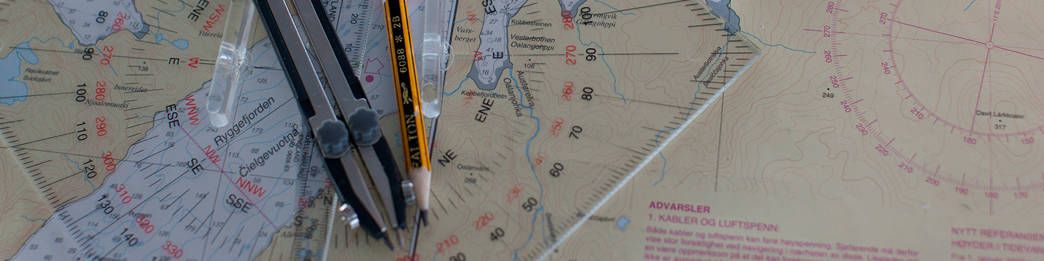 Pens and rulers on a Norway map. (photo)