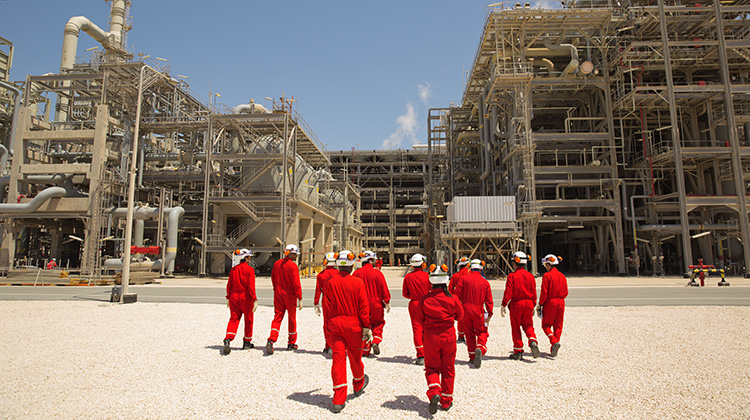 Engineer graduates walk towards the Pre-treatment section of the SGP’s unit within the GTL area of Pearl Plant, Quatar. (photo)