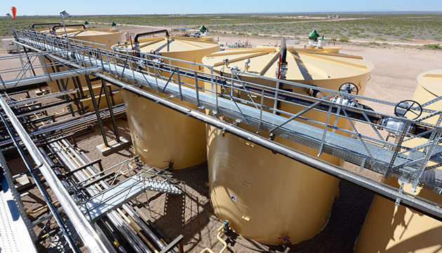 The central processing facility for our Permian asset in West Texas, USA. The facility separates the oil from associated gas, water and sand (photo)