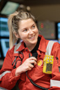 Shell employee in workwear sitting in a control center with radio equipment. (photo)