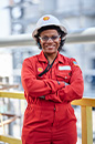 Smiling Shell employee in PPE with her arms crossed at Shell facility in USA (photo)