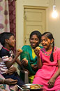 Grandmother, mother and two kids are having dinner in India (photo)