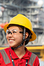 woman in PPE smiling in front of Whale platform (photo)