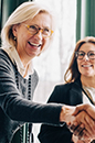 Shell strongly supports a transparent and coordinated approach to improving the global tax system image of female business executive shaking hands with another executive in a meeting (photo)