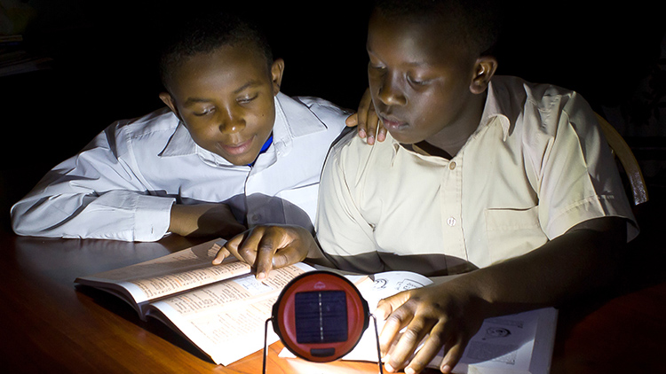 Two boys studying using Dlight (photo)