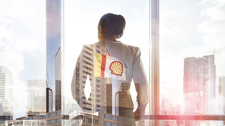 Office employee with Shell pecten flag in the background (photo)