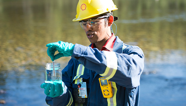 Greater Deep Basin - A Shell Water Coordinator collects a water sample from Town of Fox Creek water treatment facility located near Fox Creek, Alberta, Canada. (photo)