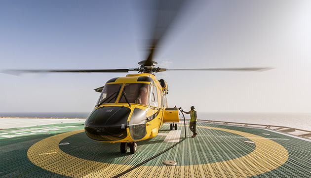 Yellow helicopter on a helipad at the Perdido offshore deepwater platform in the Gulf of Mexico, USA. (photo)