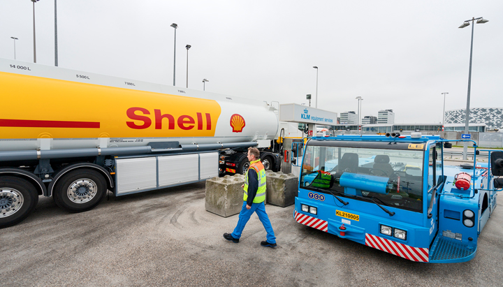 Ground support vehicles and a Shell fuel tanker at Amsterdam Schiphol Airport in the Netherlands (photo)