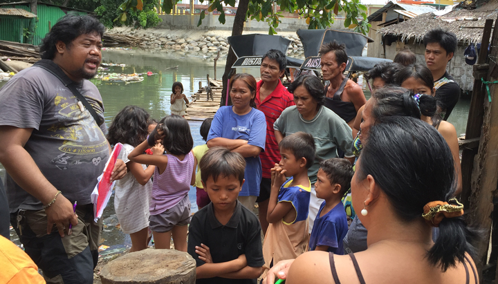 Community Coordinator Mark Brazil meets with informal settlers living near to an import terminal, Philippines (photo)