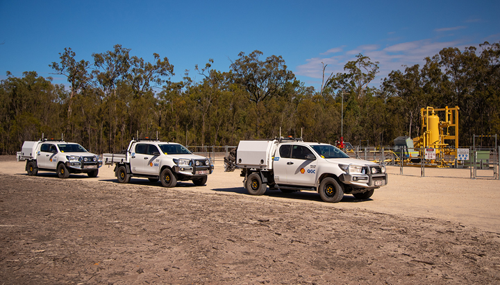 Three trucks parked at a QGC facility in Queensland, Australia. (photo)