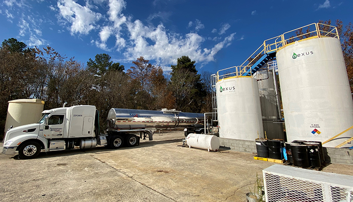 A tanker truck parked alongside two product tanks at the Nexus facility in the USA. (photo)