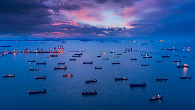 Aerial view of numerous ships at the tanker park in Singapore at dusk. (photo)