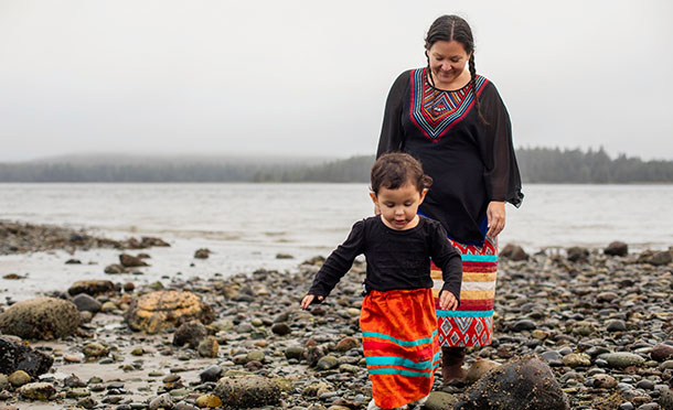 Indigenous Mother and child  exploring near the ocean in Haida Gwaa (photo)