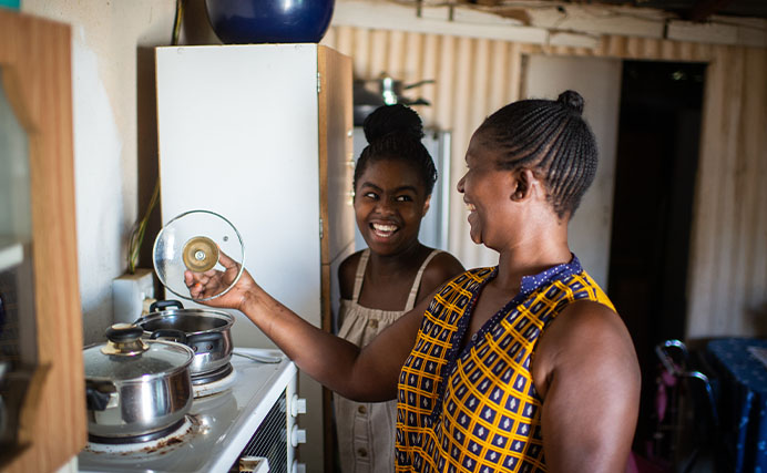 mother and daughter cooking together at home in South Africa (photo)