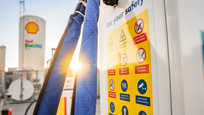 Sun shining on Shell Renewable Diesel pump showing safety icons for your safety (photo)