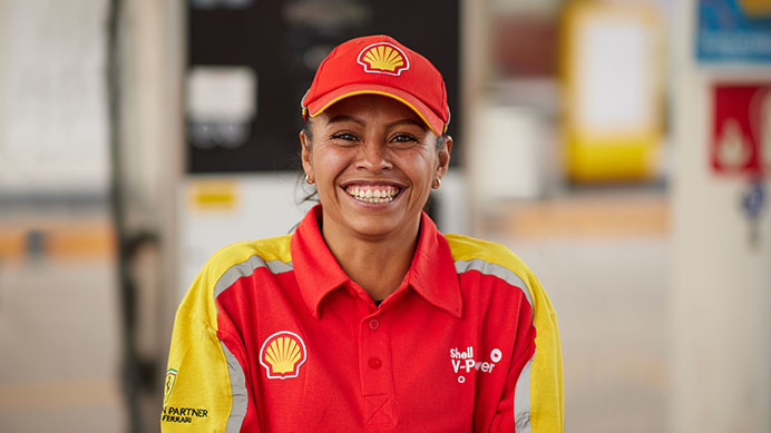 Smiling Service Champion wearing Shell branded workwear