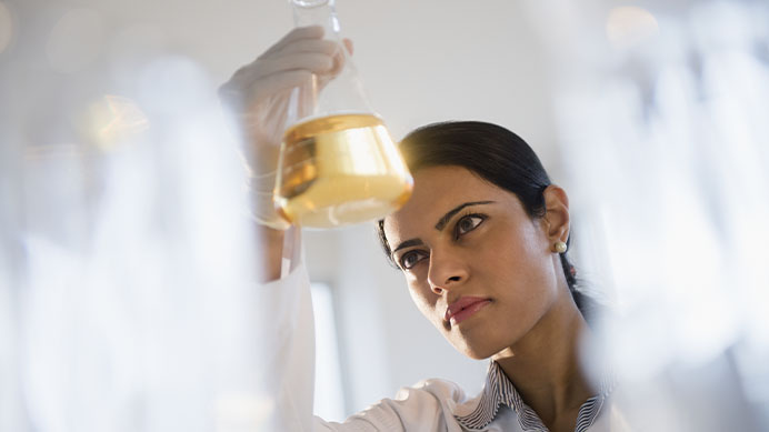 Indian scientist examining chemicals in lab (photo)