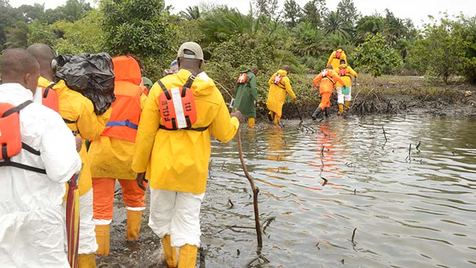 A shoreline clean-up and assessment team inspect a creak in Nigeria