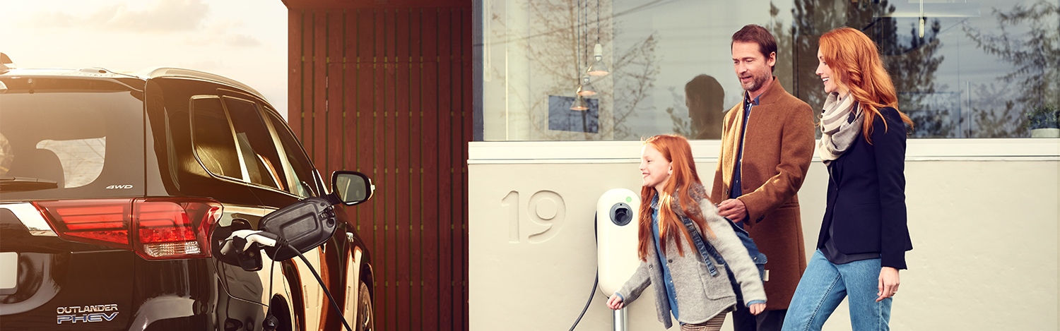 Chapter entry image: A family in the UK charges their electric vehicle at home. (photo)