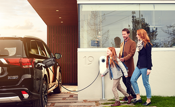 A family in the UK charges their electric vehicle at home. (photo)