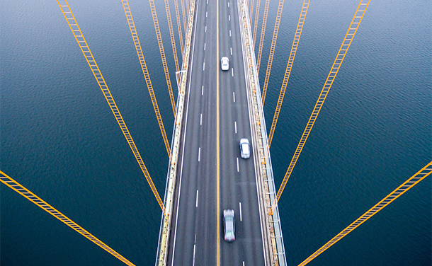 An aerial view of a bridge with cars on it. (photo)