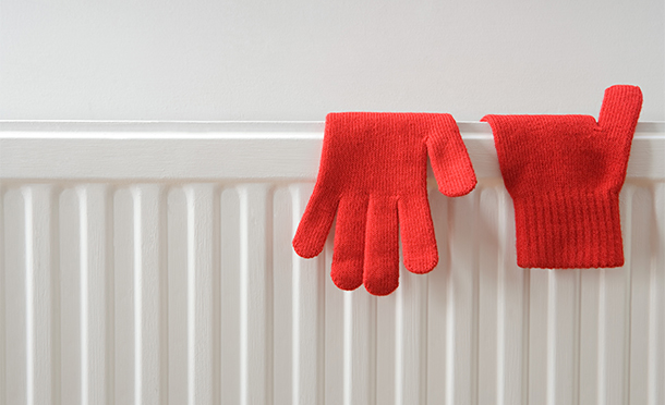 A radiator with gloves on it. (photo)