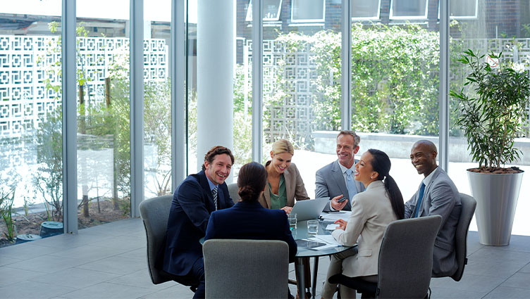 Group of executives sitting around a table in a meeting room  (photo)
